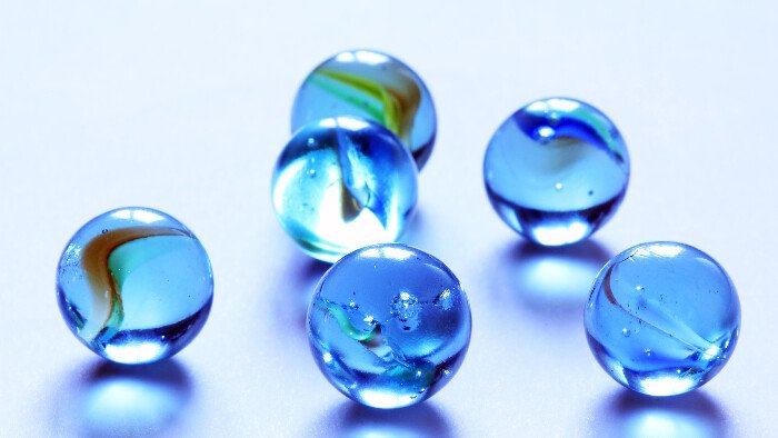 Blue-marble-technique pain white background displaying blue marbles that are hypnobirthing pain technique