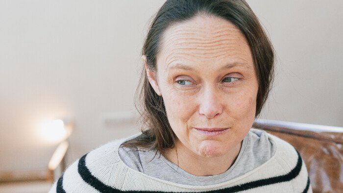 describing how glove anaesthesia works, hypnotherapist steph mcgee wearing a white woollen jumper with black horizontal stripes eyes turned away from camera with a quizzical look 